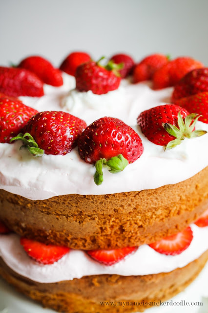 Gorgeous! This Strawberry Lemonade Cake has a tangy whipped cream "frosting". The fresh strawberries and lemon cake make it all that much better! | mynameissnickerdoodle.com