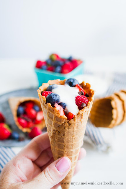 Easy and Sweet Summer Berry Cones. Sprinkled with a few chocolate chips and topped with fresh whipped cream. The perfect summer treat! | mynameissnickerdoodle.com