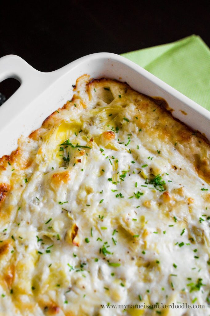 The BEST cheesy artichoke dip EVER!!! It's made with three cheese and served hot. | mynameissnickerdoodle.com