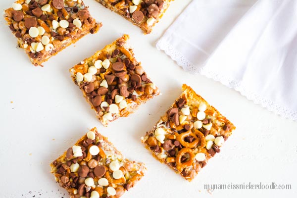 Here is a twist on the classic Magic Cookie Bars recipe. These Magic Caramel Pretzel Cookie Bars are the perfect salty sweet treat! | mynameissnickerdoodle.com